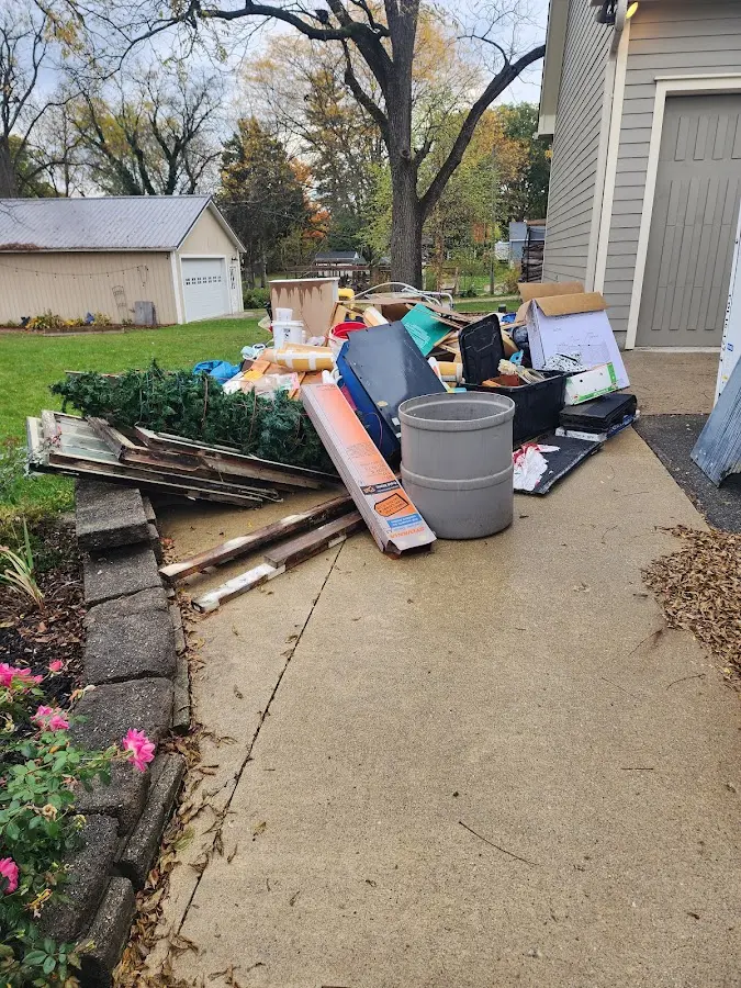 Dumpster being loaded with debris for Estate Cleanout Dumpster Rental in Huntley